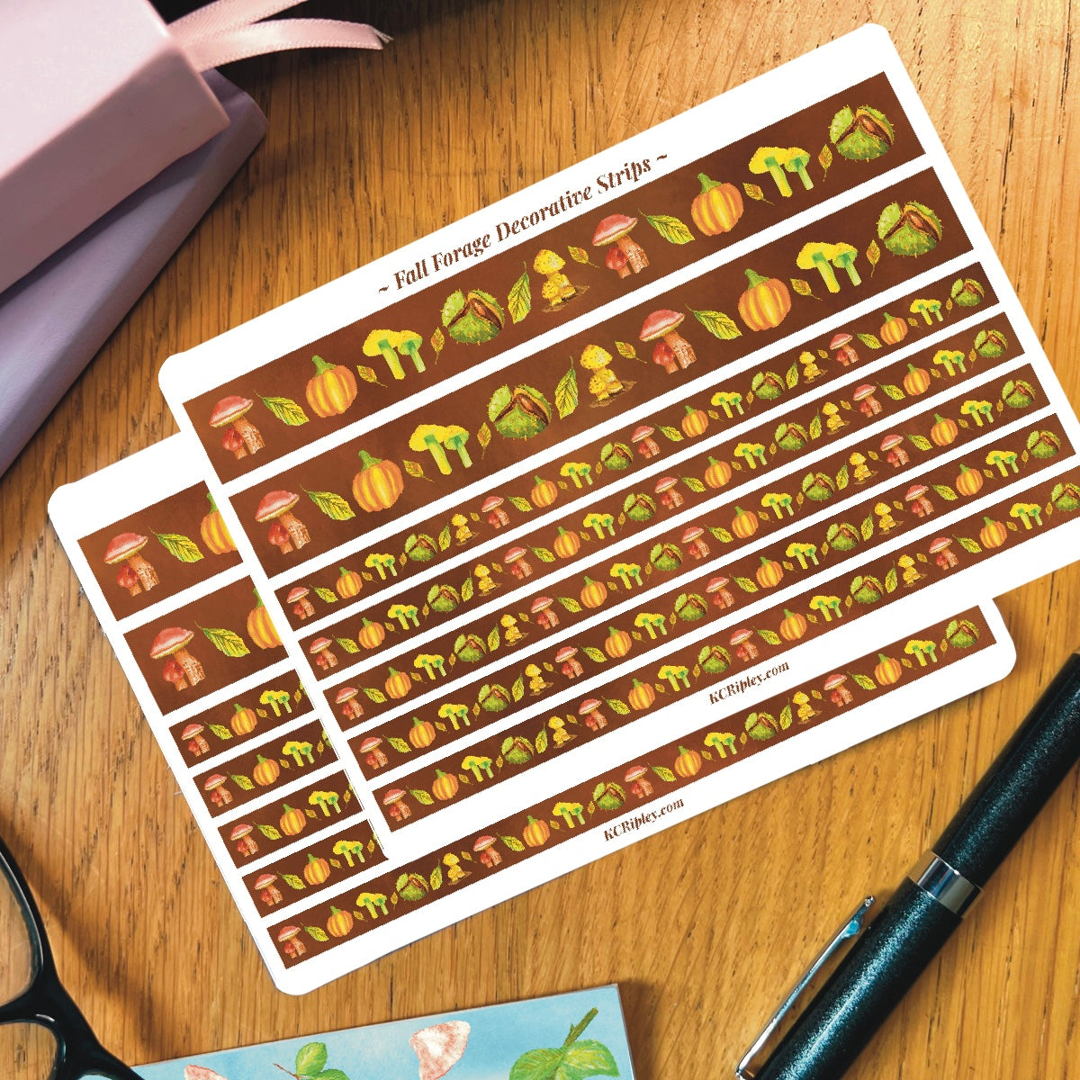 2 White sticker sheets with 2 wide and 5 narrow sticker strips in a warm brown with a repeating botanical pattern featuring mushrooms, conker, and pumpkins