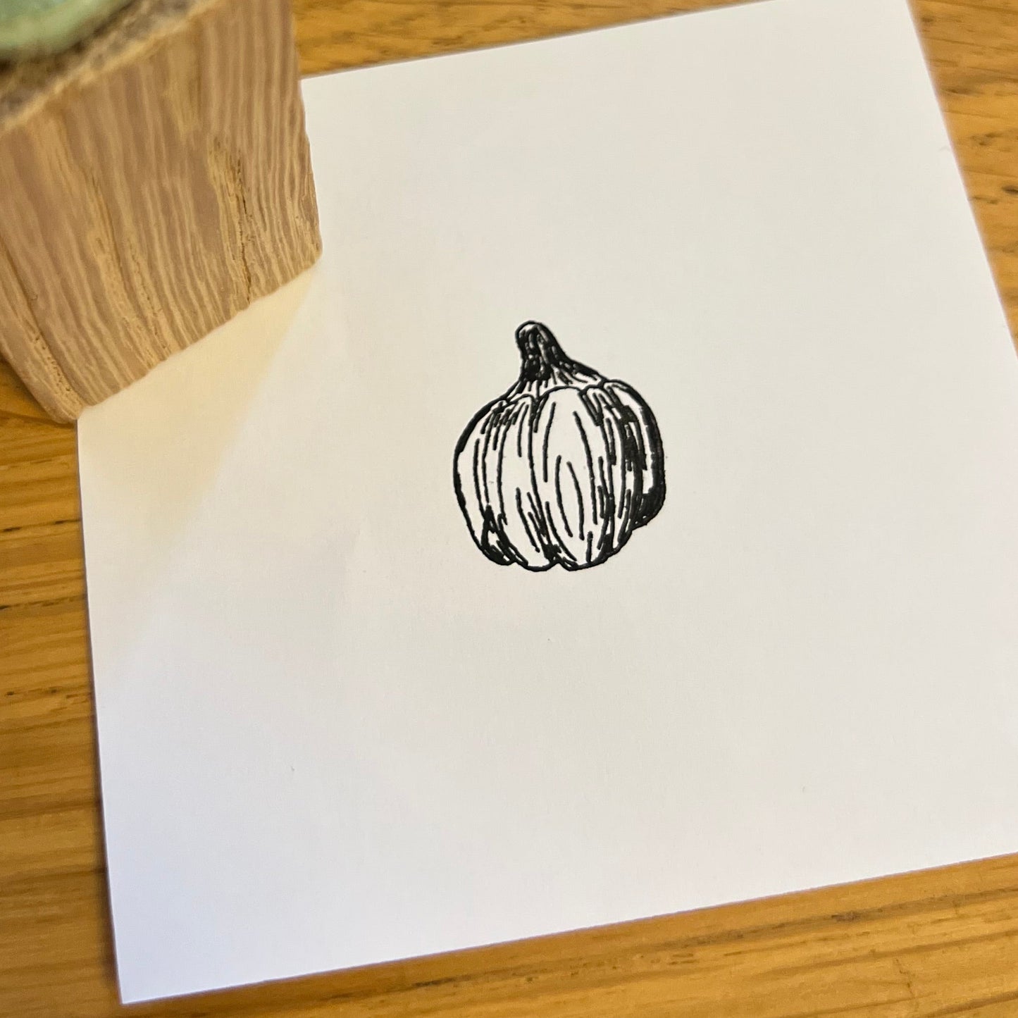 Pumpkin stamped in black ink on white paper