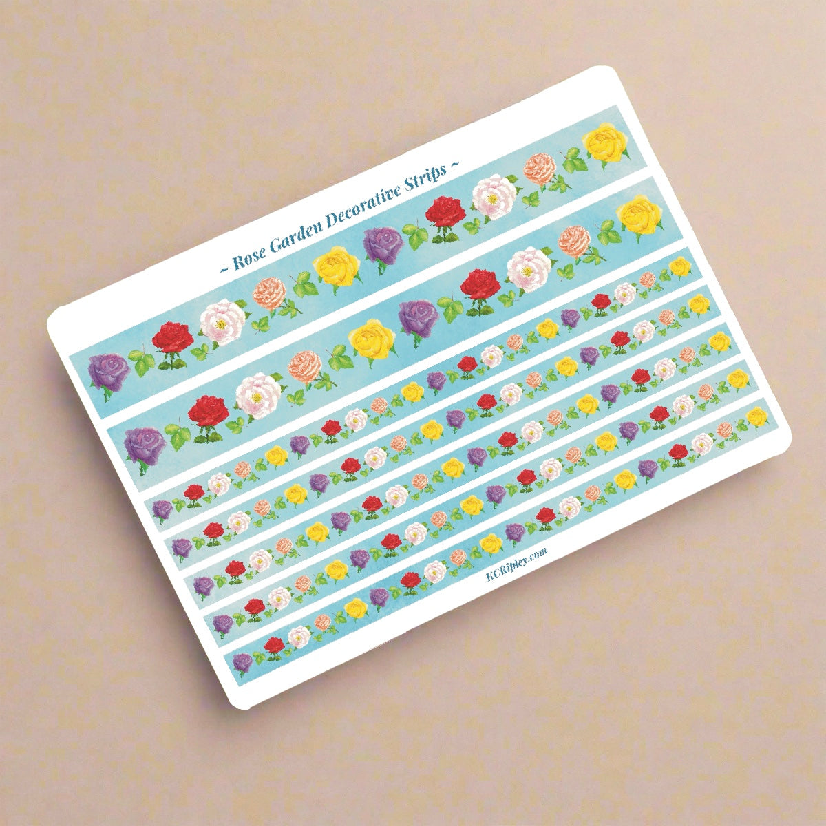 White sticker sheet with 2 wide and 2 narrow sticker strips. Strips are light blue with a repeating pattern of colourful roses