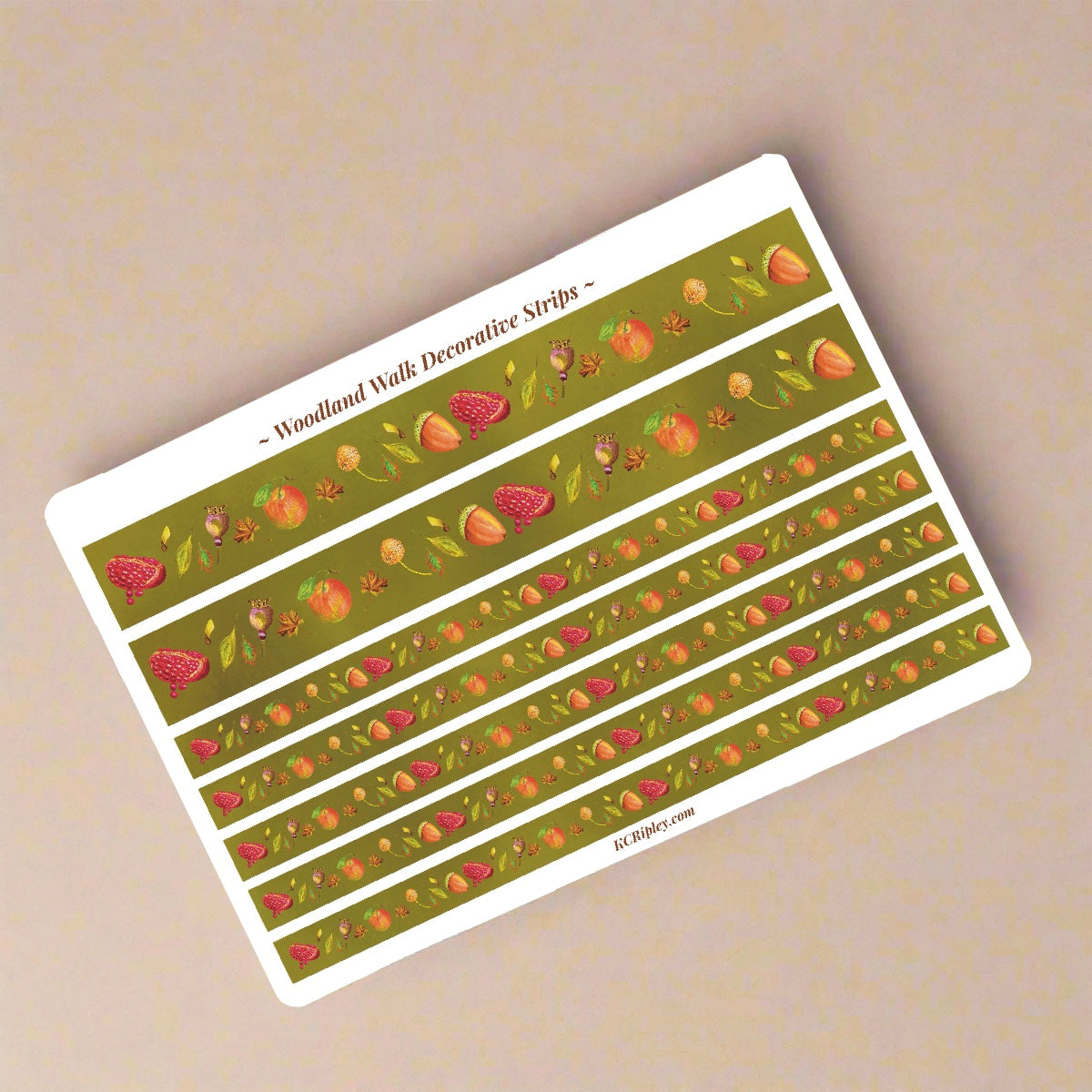 White sticker sheet with 2 wide and 5 narrow sticker strips in a moss green with a repeating botanical pattern featuring pomegranates, acorns, seeds and apples